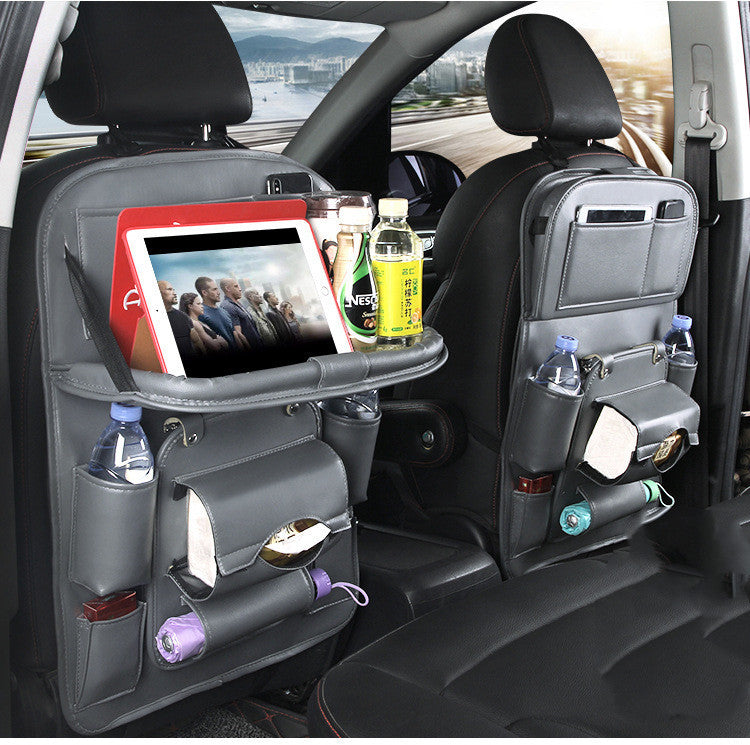 CJ black leather car seat organizer with multiple pockets and tray holding tablet and bottles