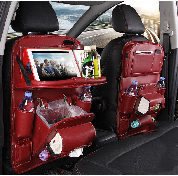 Red leather car seat organizer attached to front seats with multiple compartments for bottles, tablet, snacks, and tissues
