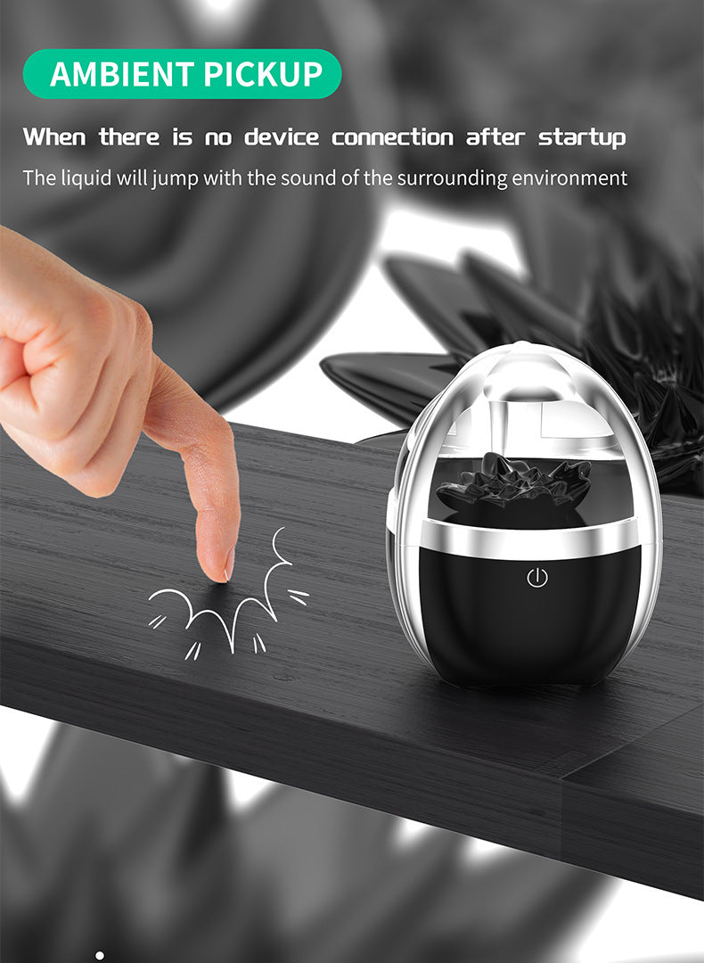 Fluid Bluetooth automotive accessory with ambient pickup feature on black surface by hand